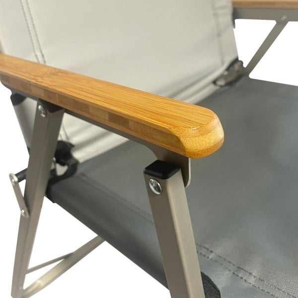 A closeup of the Ultralight Folding Chair from OLPRO wooden armrests.