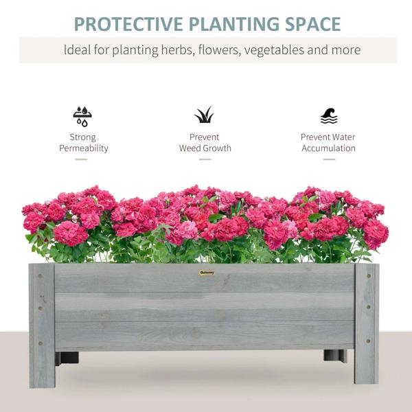 Grey raised garden planter box filled with pink flowering plants