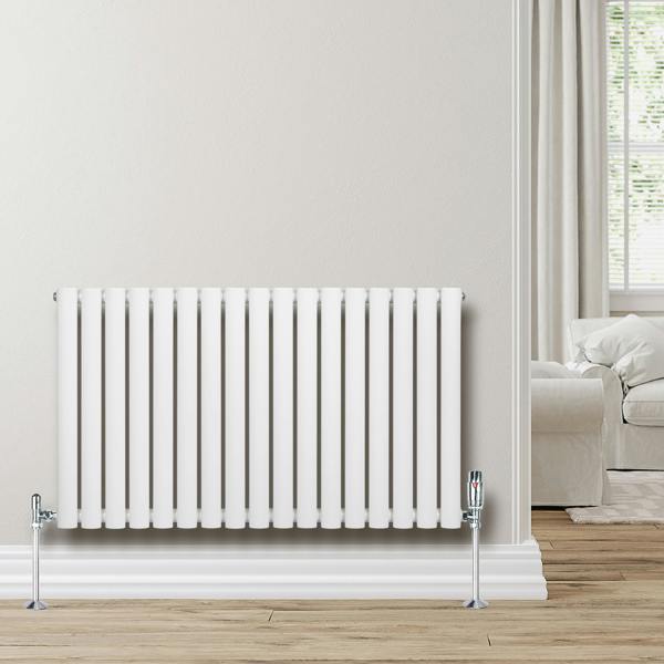 Oval single column radiator in white, 600 x 1020mm, featuring sleek vertical lines and chrome valves, set against a light wall and wooden floor