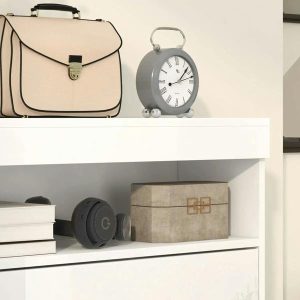 White shoe storage cabinet with open flip doors, stacks of storage items inside