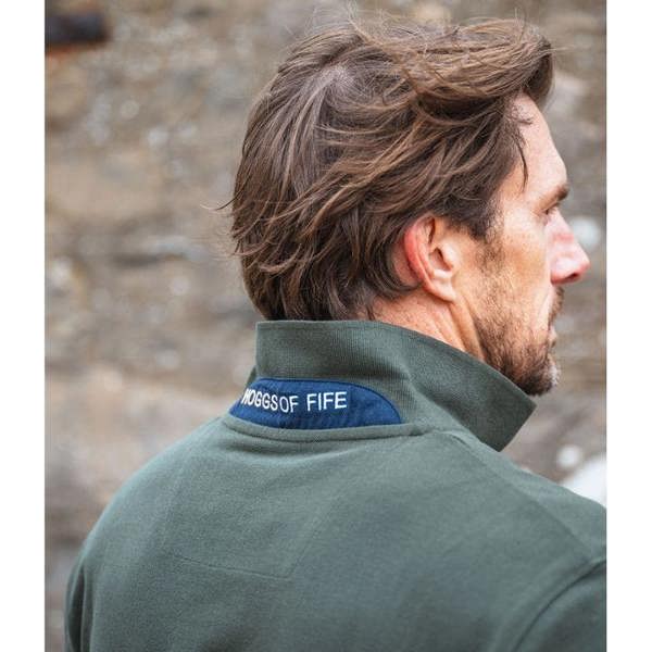 Man outdoors in forest green Hoggs of Fife Newton polo shirt, smart country outfit for casual workdays or weekend wear
