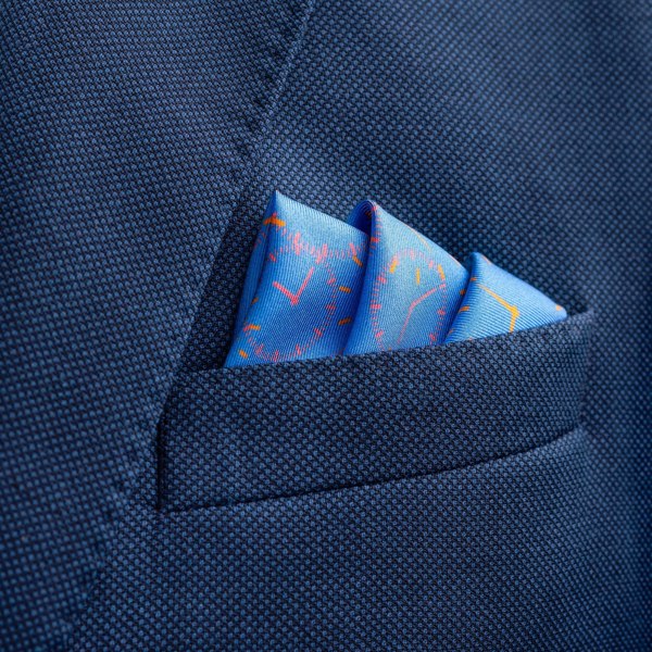 Chronos watch dial design silk pocket square in mid blue by Otway & Orford folded in top pocket