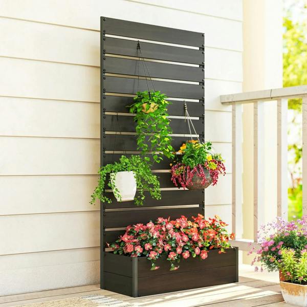 Black raised trellis planter box with multiple shelves of blooming plants