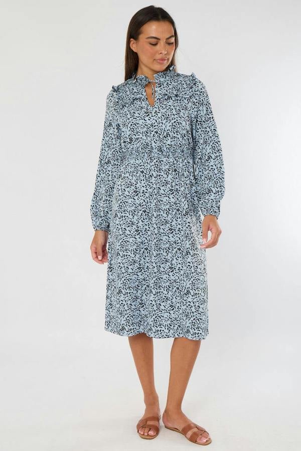 Woman wearing a blue floral dress on a white background