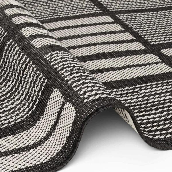 Close-up of a black and white striped rug with geometric pattern