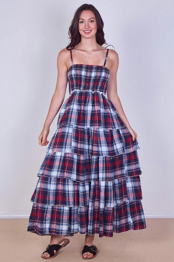 Woman wearing a plaid dress with a white background