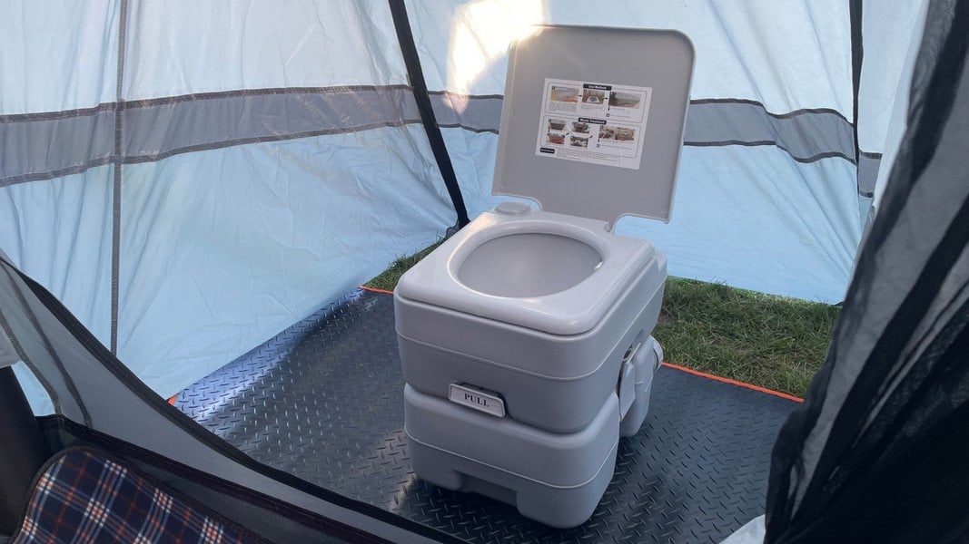 An image from Inside of the Cocoon Breeze XL V2 Motorhome Awning showing the a toilet inside the side pod.