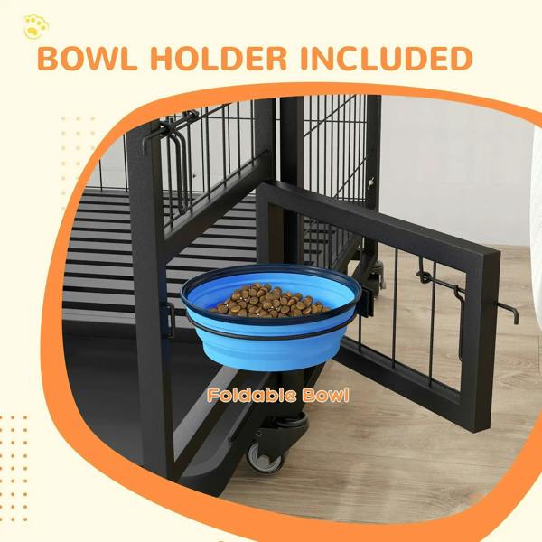 Black dog crate with foldable blue bowl holder mounted at the front opening