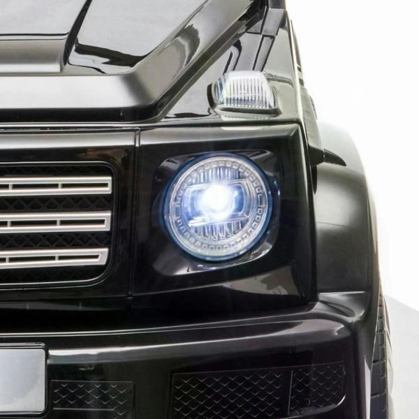 Close-up of black kids electric ride-on car front headlight with bright LED glow