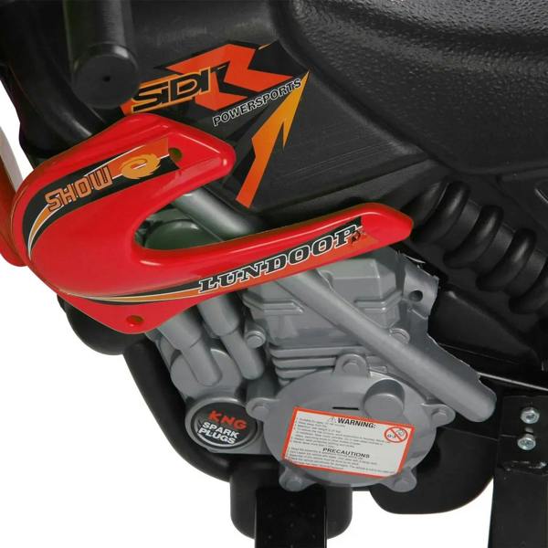 Red motorbike engine area with decorative graphics and warning label
