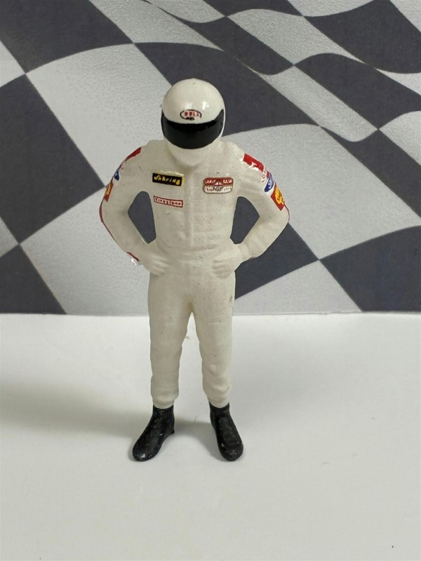 a toy figure of a race car driver