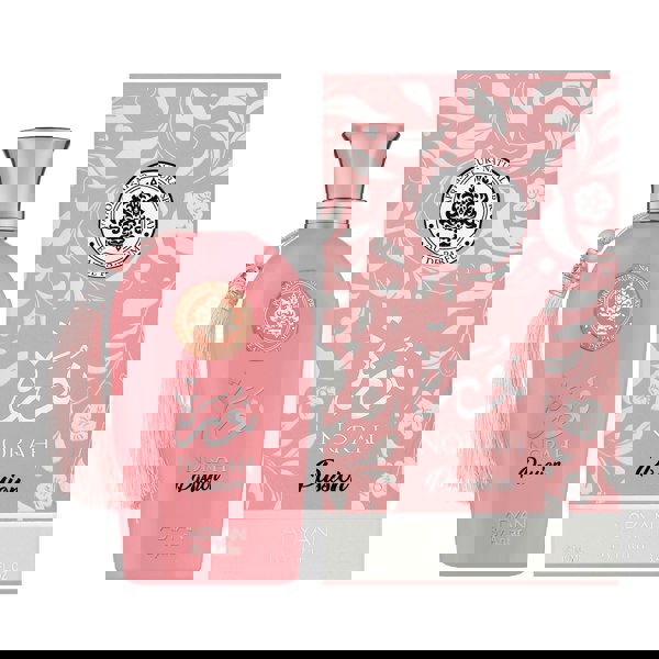 adyan Norah_Passion Pink perfume bottle with silver cap and tassel next to its packaging on a white background