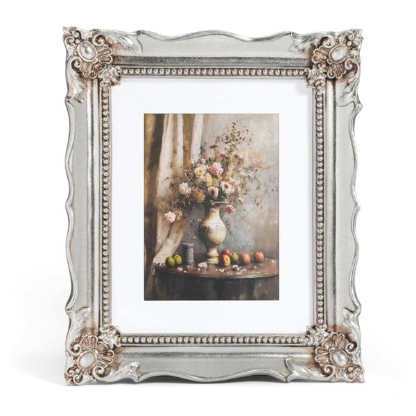 Decorative silver frame with a floral still life painting inside