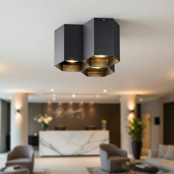 black surface mounted ceiling spotlight mounted in a hotel reception area
