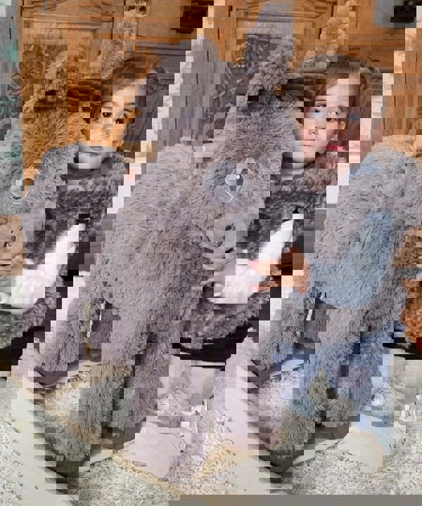 Toddler hugging Norbert Rocking Donkey soft brown plush fabric