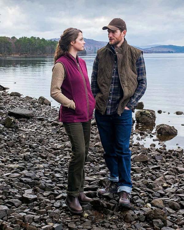 Man and women on beach wearing Hoggs of Fife Stenton fleece gilet