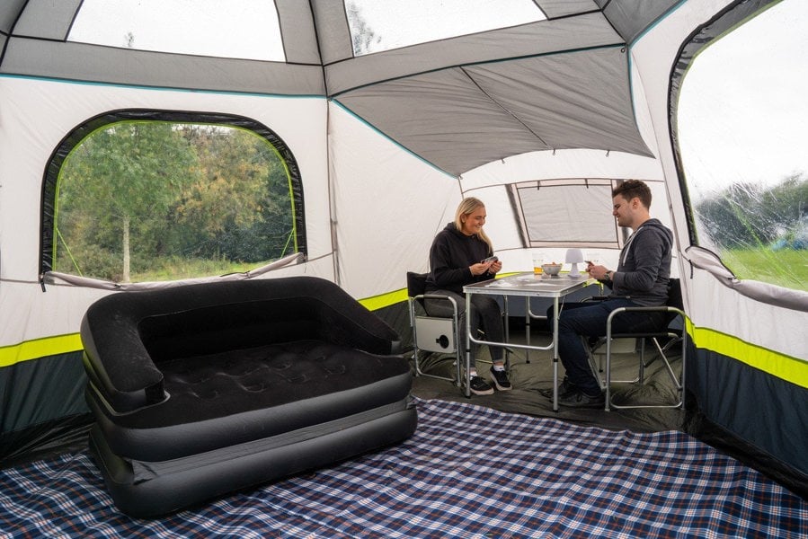 An adult couple inside of the Hive Campervan Awning Fibreglass Poles - with Sleeping Pod from OLPRO whilst playing cards.