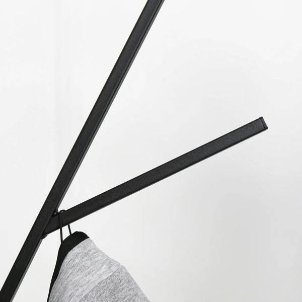 Coat rack hook arm with a hanging gray coat on a black metal stand