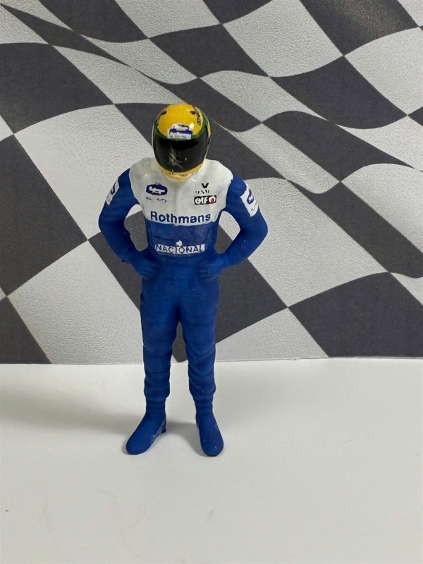 a toy figure of a race car driver