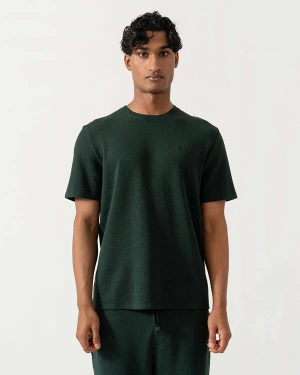 Man wearing BOSS Orange Waffle Mens Cotton-Blend Pyjama T-Shirt with Embroidered Logo - Dark Green 308