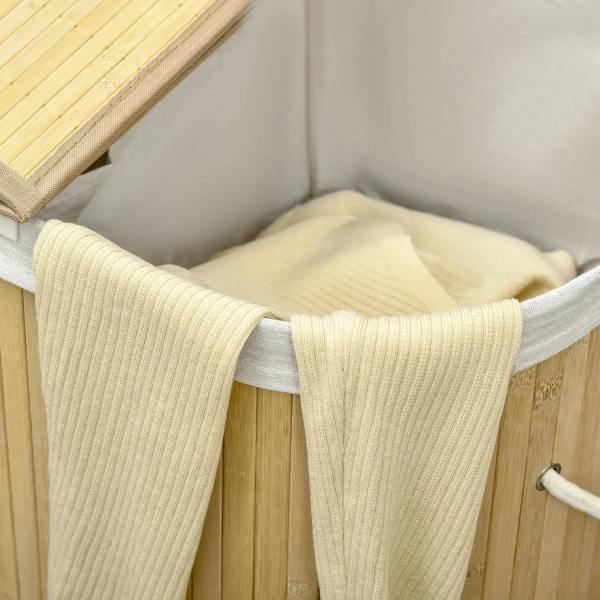 Interior of natural bamboo laundry basket with removable gray liner and rope handles