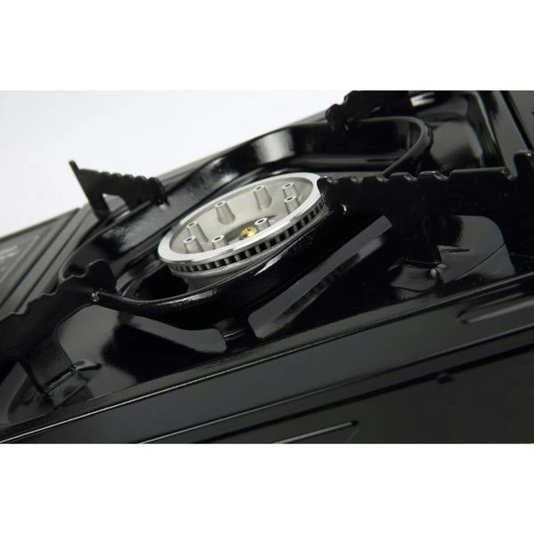 Close-up of a black stove burner with removable pan supports