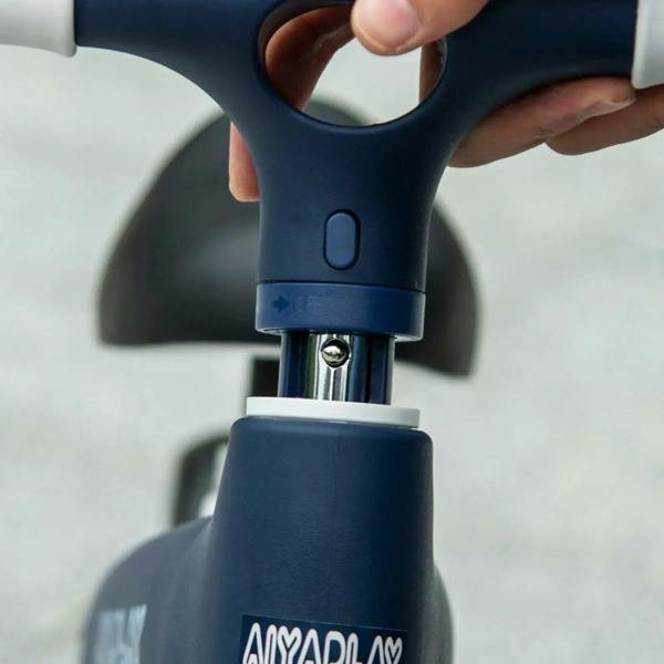 Blue balance bike seat height adjuster with metal clamp under black saddle