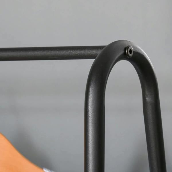 Close-up of black A-shaped metal frame of a hanging coat rack