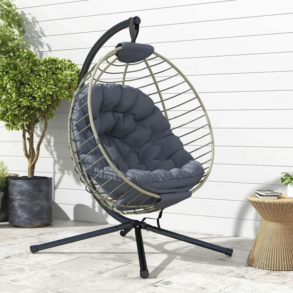 Grey hanging rattan swing chair with metal stand, tufted cushion, and small cup holder