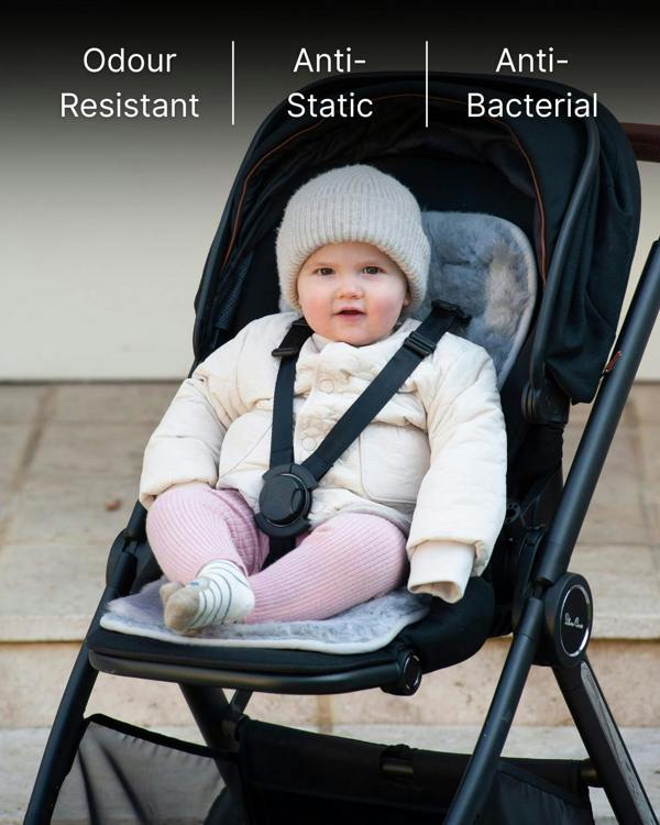 Child in a stroller with skeepskin liner