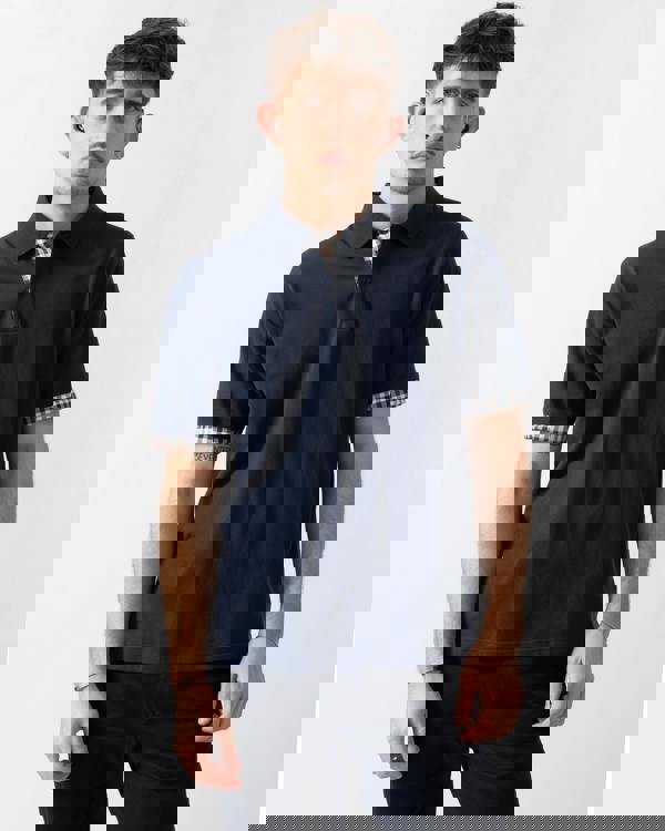 studio shot of a model wearing an Aquascutum Mens Club Check Stretch Piquet Sleeves Polo Shirt in Navy 11