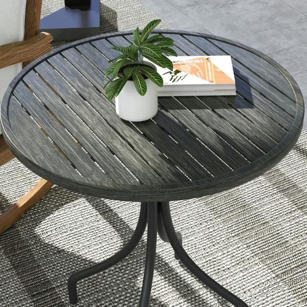Close-up of grey round slatted tabletop with potted plant and curved steel base