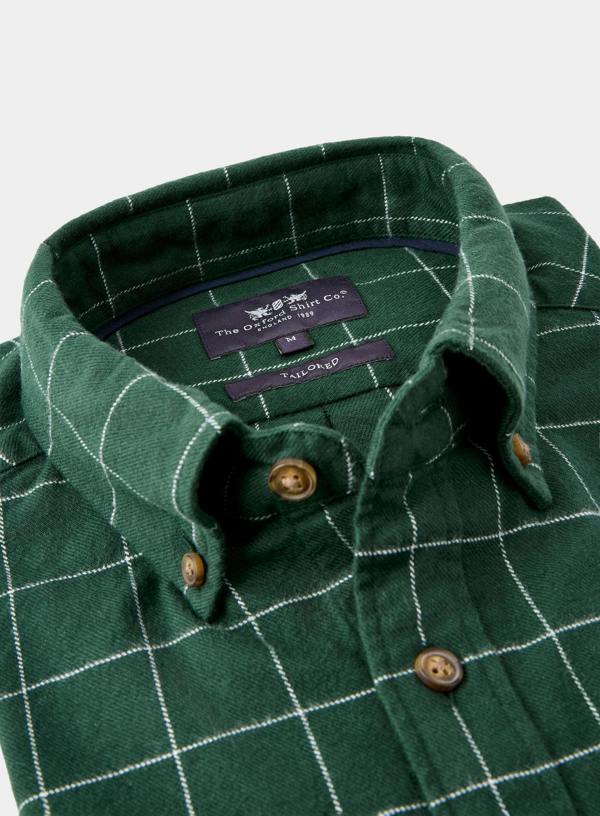 Green checkered shirt with collar and button details, featuring a brand label.