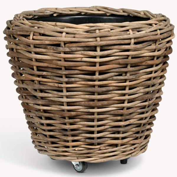 Front studio view of the XXL rattan planter on wheels with black liner visible.