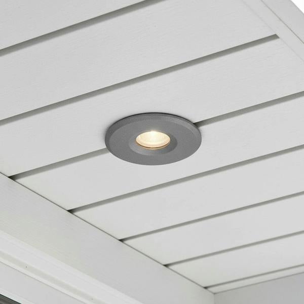 grey small soffit light mounted in a white house soffit 