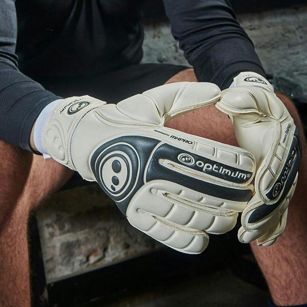 Goalkeeper wearing white and navy Optimum gloves resting hands on knees - Optimum