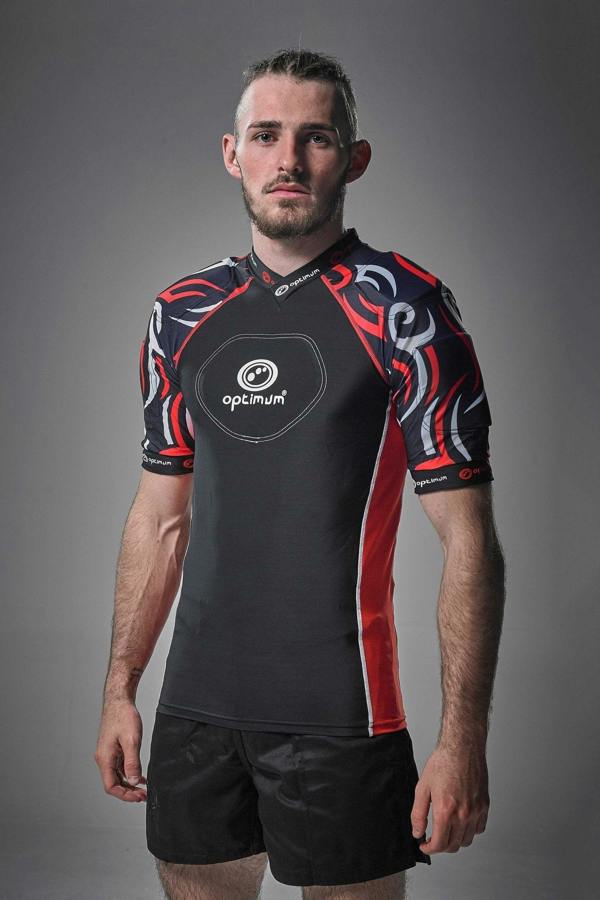 Black Optimum Razor protective top with red tribal-print padded shoulders, front view on model - Optimum