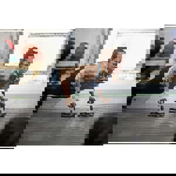 Woman performing push-ups with the Adidas Premium Push Up Bars