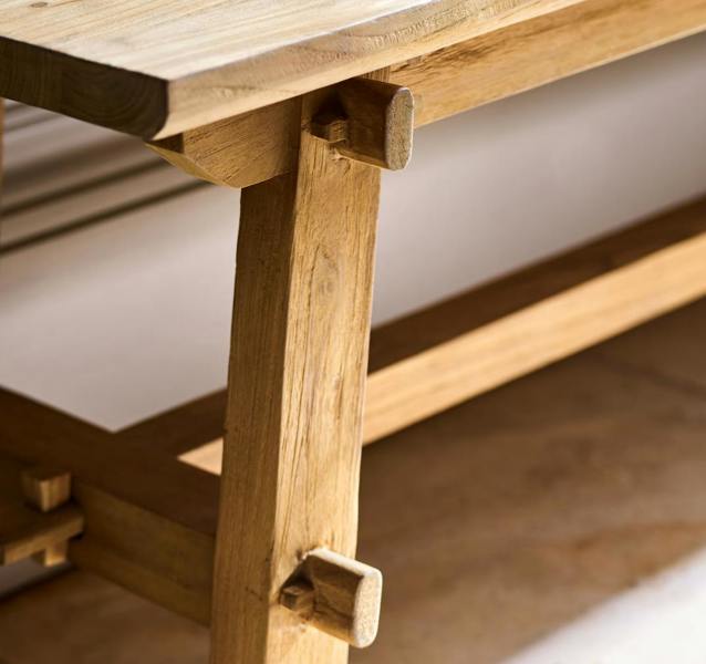 Close-up of the visible joint detailing and trestle leg of the bench.