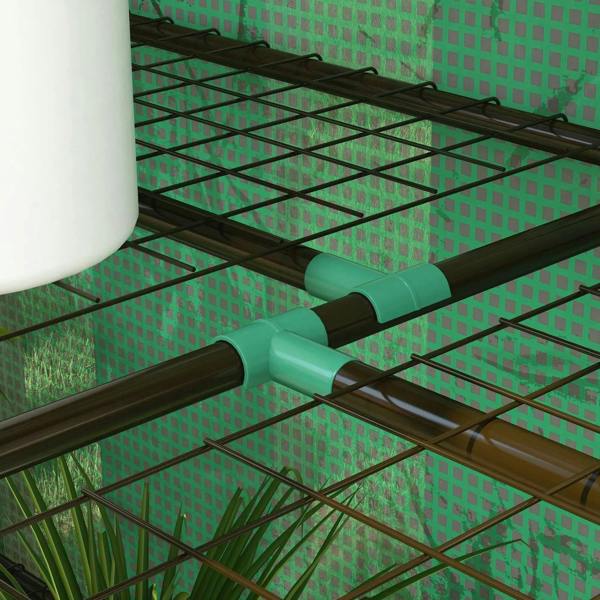 Interior view of green mini greenhouse with metal frame and wire shelf grid