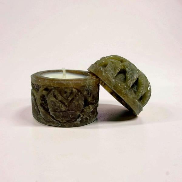 Decorative candle holder with intricate design on a white background