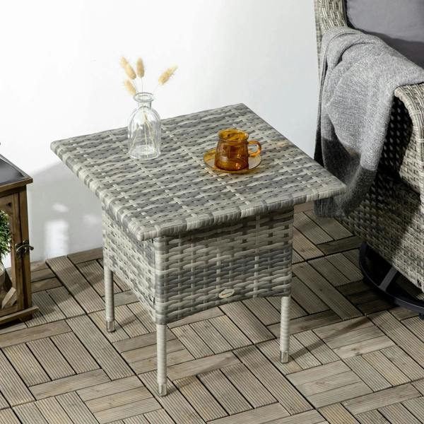 Grey woven side table with square top and cups on a patio