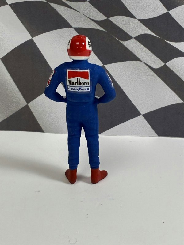 a toy figure of a man wearing a helmet