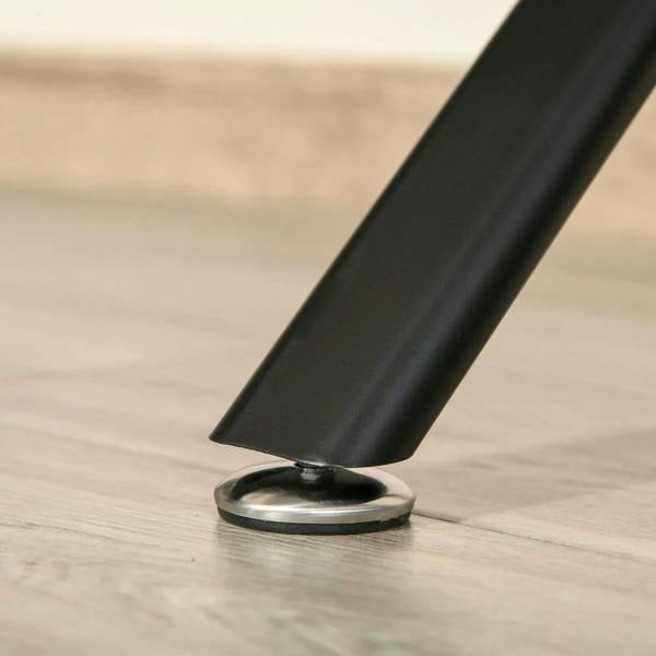 Black desk leg with foot base on light wood floor