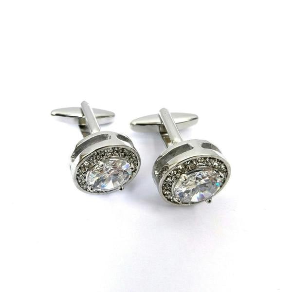 Round silver cufflinks with gemstone accents from PAMONI, featuring a polished metal finish and elegant design.