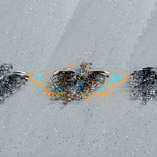 Moth brooch, gold tone metal, enamel wings in blue and orange with black detailing, body encrusted with clear crystals, nature inspired jewellery design, vintage style accessory, unique statement brooch, elegant gift for her

