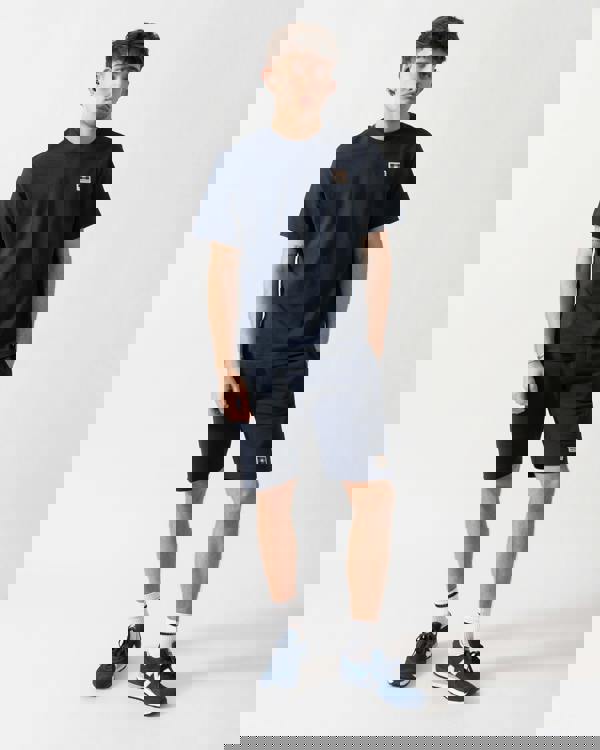 full length shot of a model wearing an Aquascutum Mens Badge T-Shirt in Navy 11