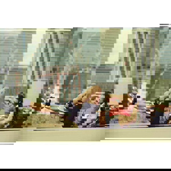 Woman and man performing ab crunches whilst wearing Reebok Ankle Weights - 1kg 