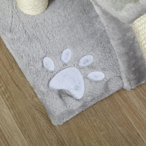Grey plush cat tree base with white paw-print pattern on soft carpet