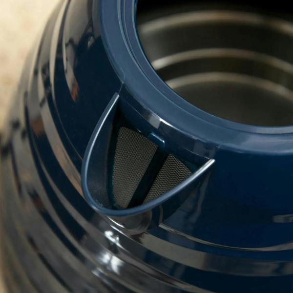 Close-up of blue kettle lid and spout area with curved metal rim